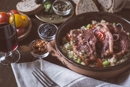 Lamb Loin Chops Freshly Roasted with Soybean and Couscous in Rustic Clay Dishの写真素材