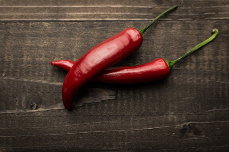 Chili Peppers on Dark Rustic Wooden Backgroundの写真素材