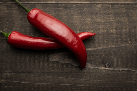 Chili Peppers on Dark Rustic Wooden Backgroundの写真素材