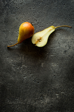 Organic Pears on Rustic Dark Background with Copy Spaceの写真素材