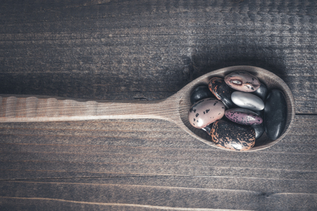 Organic Colorful Beans and Wooden Spoon on Dark Background