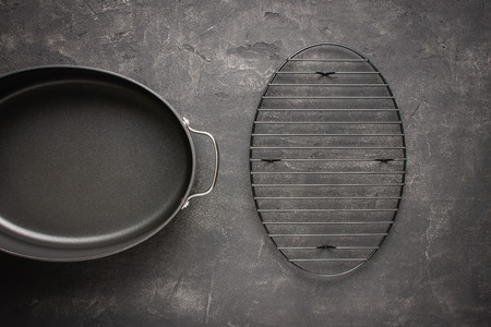 Empty Gray Nonstick Baking Dish with Handles on Dark Stone Surface. Culinary Background.の写真素材