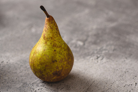 Organic Pear on Dark Stone Background. Healthy Eating Concept with Copy Space.の写真素材