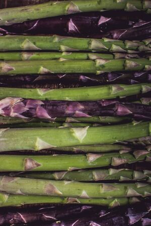Raw Organic Asparagus in Juta Bag on Dark Wood Backgroundの写真素材