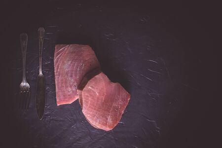 Fresh Steak of Raw Tuna on Dark Stone Backgroundの写真素材