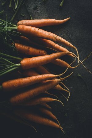 Fresh Organic Nantes Carrots on Dark Background. Healthy Food.の写真素材