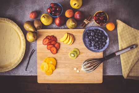 Preparation of Fruit Pie with Colorful Fruits and Fresh Dough Ready to Bake. Fresh Food Concept.の写真素材