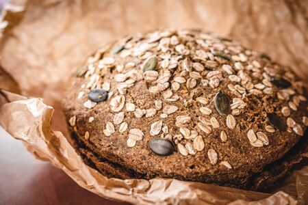 Whole Grain Traditional Rye Bread in Brown Parchment Paperの写真素材
