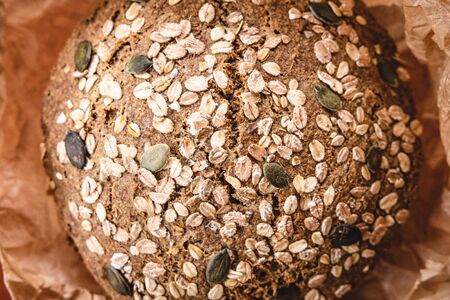 Whole Grain Traditional Rye Bread in Brown Parchment Paperの写真素材