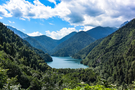 Beautiful mountain Lake Ritsa. Lake Ritsa in the Caucasus Mountains, in the north-western part of Abkhazia, Georgia, surrounded by mixed mountain forests and subalpine meadows.の写真素材