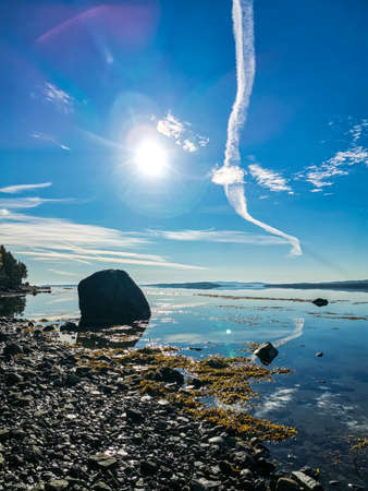 The White Sea coast on a sunny day. The sun's rays. Karelia. Russia.