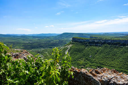 View of the picturesque Crimean mountains from the cave town of Tepe-Kermen in summer. May. 2021. Crimea.の写真素材