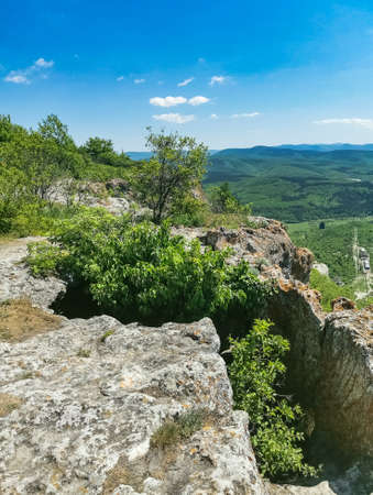 View of the picturesque Crimean mountains from the cave town of Tepe-Kermen in summer. May. 2021. Crimea.の写真素材