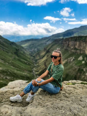 A girl on the background of the Khunzakh valley, Khunzakh waterfalls, Dagestanの写真素材