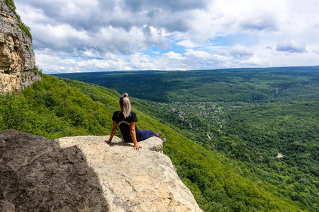 A girl on the background of the landscape of the Caucasus Mountains - The Eagle Rocks Mountain shelf, Mezmaiの写真素材