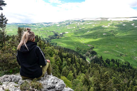 A girl on the background of alpine meadows of the Lago-Naki plateau in Adygea. Russia.の写真素材
