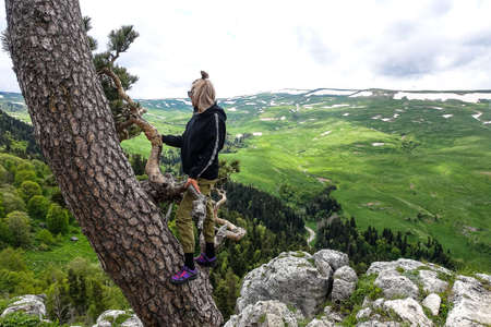 A girl on the background of alpine meadows of the Lago-Naki plateau in Adygea. Russia.の写真素材