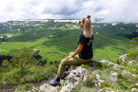 A girl on the background of alpine meadows of the Lago-Naki plateau in Adygea. Russia.の写真素材
