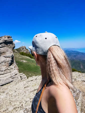 A girl on the background of ancient limestone high mountains. The Valley of Ghosts. Demerji. Crimea.の写真素材