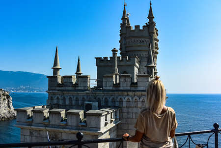 A girl on the background of a view of a Swallow's nest in the Crimea. Black Sea Russia 2019のeditorial素材