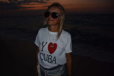 A girl on the evening coast of Cuba, Varadero, the waters of the Atlantic Ocean. Cuba 2019.の写真素材