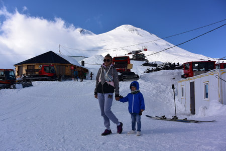 Elbrus 2019: A girl with a child at the Mir station of the highest cable car in Europe, Russiaの写真素材