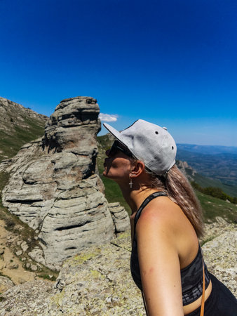 A girl on the background of ancient limestone high mountains. The Valley of Ghosts. Demerji. Crimea.の写真素材