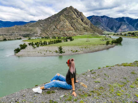 A girl on the background of the Katun River - the main waterway of the Altai Mountains. Altai. 2020.の写真素材