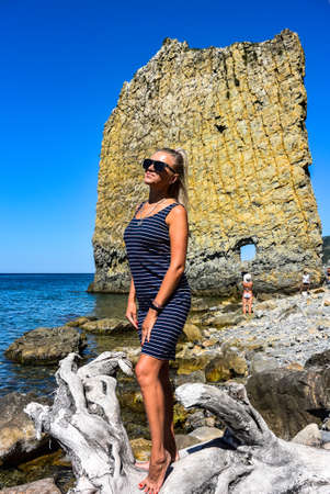 A girl on the background of a giant, sail-like rock called Sail on the Black Sea coast, Gelendzhik.の写真素材