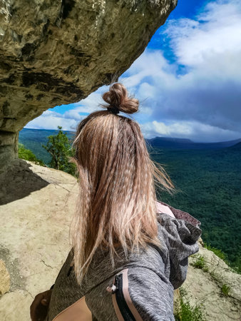 A girl on the background of the landscape of the Caucasus Mountains - The Eagle Rocks Mountain shelf, Mezmai. 2021の写真素材