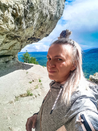 A girl on the background of the landscape of the Caucasus Mountains - The Eagle Rocks Mountain shelf, Mezmai. 2021の写真素材