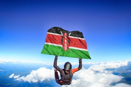 Kenya extreme. Flag in skydiving. People in free fall grab flag of Kenya. Patriotism, men and flag.の写真素材
