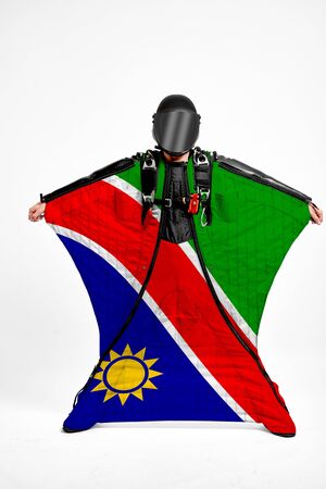 Namibia extreme. Flag in skydiving. People in free fall grab flag of Namibia. Patriotism, men and flag.の写真素材