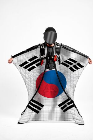 South Korea extreme. Flag in skydiving. People in free fall grab flag of South Korea. Patriotism, men and flag.の写真素材