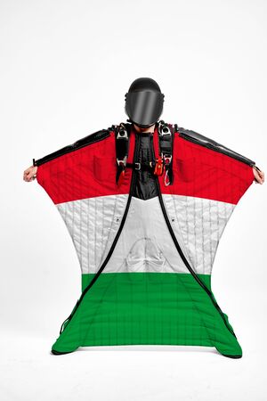 Italy extreme. Flag in skydiving. People in free fall grab flag of Italy. Patriotism, men and flag.の写真素材