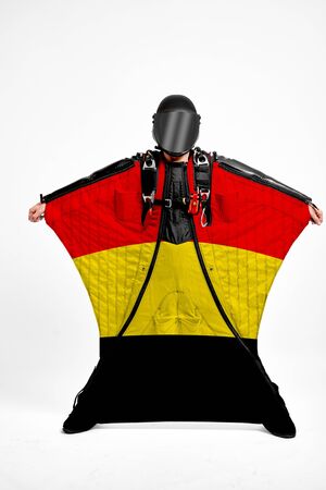 Belgium extreme. Flag in skydiving. People in free fall grab flag of Belgium. Patriotism, men and flag.の写真素材