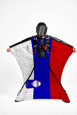 Slovenia extreme. Flag in skydiving. People in free fall grab flag of Slovenia. Patriotism, men and flag.の写真素材
