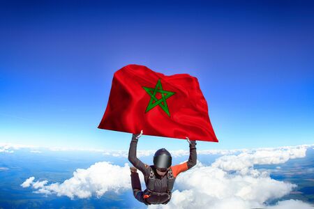 Morocco extreme. Flag in skydiving. People in free fall grab flag of Morocco. Patriotism, men and flag.の写真素材