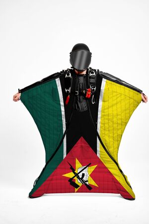 Mozambique extreme. Flag in skydiving. People in free fall grab flag of Mozambique. Patriotism, men and flag.の写真素材