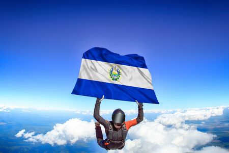 Salvador extreme. Flag in skydiving. People in free fall grab flag of Salvador. Patriotism, men and flag.の写真素材
