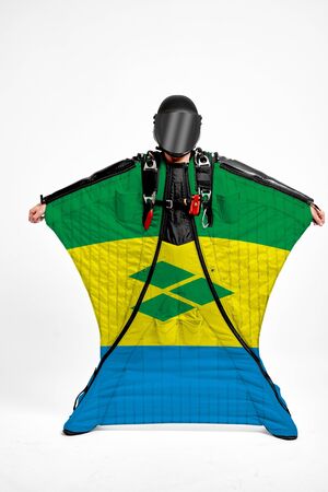 Sant Vincent and the Grenadines extreme. Flag in skydiving. People in free fall grab flag of Sant Vincent and the Grenadines. Patriotism, men and flag.の写真素材