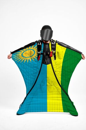 Rwanda extreme. Flag in skydiving. People in free fall grab flag of Rwanda. Patriotism, men and flag.の写真素材