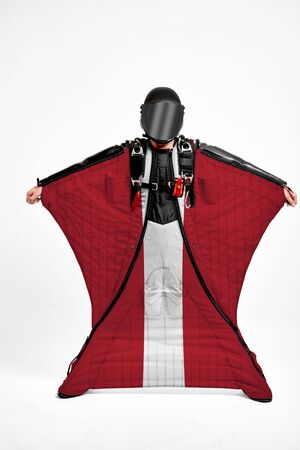 Latvia extreme. Flag in skydiving. People in free fall grab flag of Latvia. Patriotism, men and flag.の写真素材