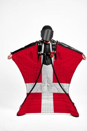 Denmark extreme. Flag in skydiving. People in free fall grab flag of Denmark. Patriotism, men and flag.の写真素材