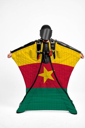 Cameroon extreme. Flag in skydiving. People in free fall grab flag of Cameroon. Patriotism, men and flag.の写真素材