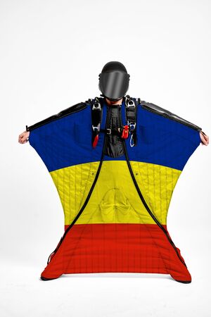 Romania extreme. Flag in skydiving. People in free fall grab flag of Romania. Patriotism, men and flag.の写真素材