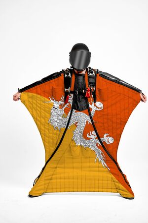 Butane extreme. Flag in skydiving. People in free fall grab flag of Butane. Patriotism, men and flag.の写真素材