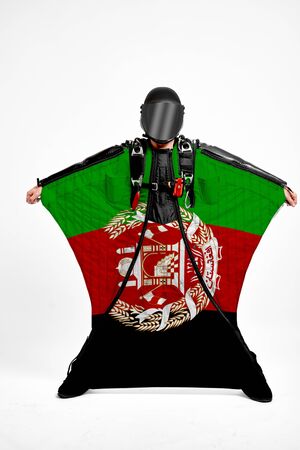 Afghanistan extreme. Flag in skydiving. People in free fall grab flag of Afghanistan. Patriotism, men and flag.の写真素材