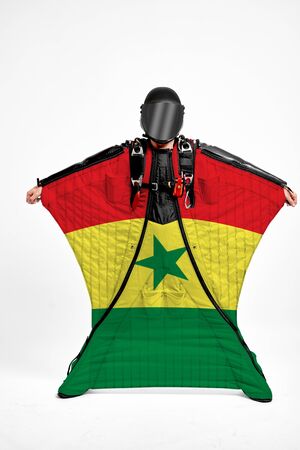 Senegal extreme. Flag in skydiving. People in free fall grab flag of Senegal. Patriotism, men and flag.の写真素材