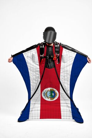 Costa Rica extreme. Flag in skydiving. People in free fall grab flag of Costa Rica. Patriotism, men and flag.の写真素材